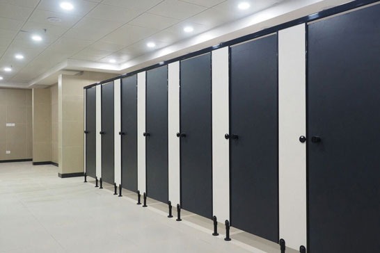 Stylish and hygienic restroom cubicles in a shopping mall, designed for high-traffic areas.