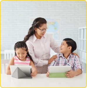 Teacher guiding two students using tablets in a classroom setting